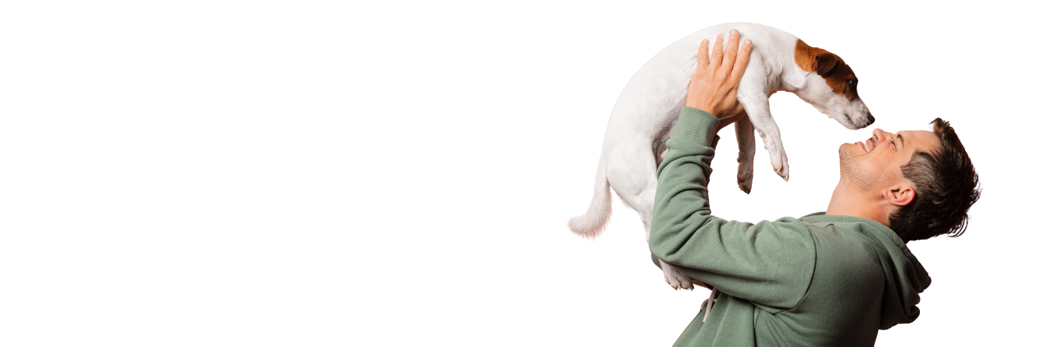 Person holding a small dog above their head on a white background
